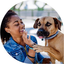 multiracial-girl-sitting-with-her-dog-outside-in